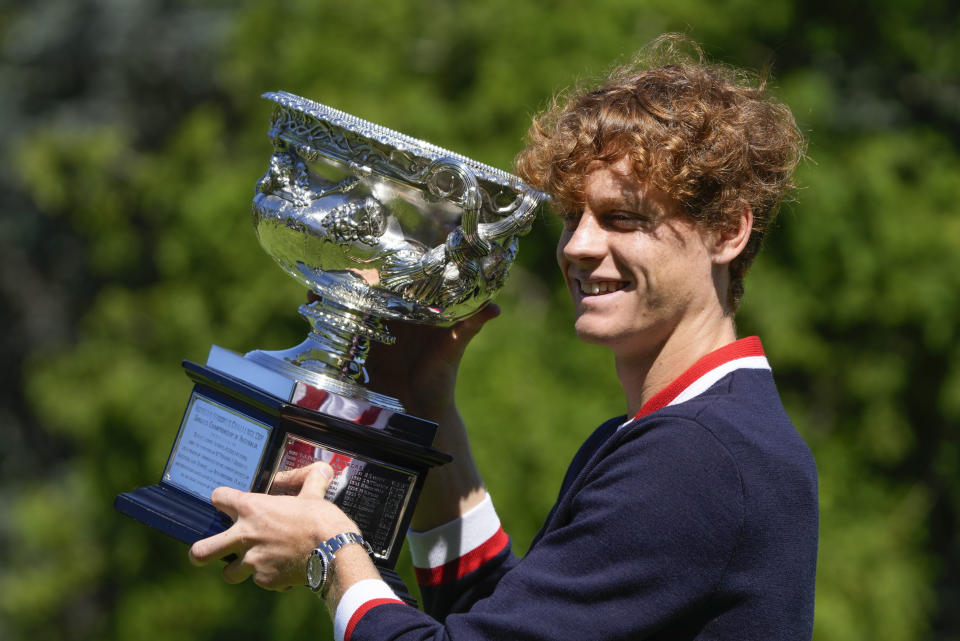 Jannik Sinner of Italy poses with the Norman Brookes Challenge Cup at a photo shoot the morning after defeating Daniil Medvedev of Russia in the men's singles final at the Australian Open tennis championships in Melbourne, Australia, Monday, Jan. 29, 2024. (AP Photo/Mark Baker)