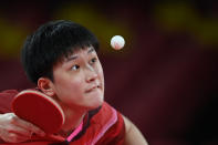 <p>Japan's Tomokazu Harimoto competes against Sweden's Anton Kaellberg during their men's team quarterfinals table tennis match Japan vs Sweden at the Tokyo Metropolitan Gymnasium during the Tokyo 2020 Olympic Games in Tokyo on August 3, 2021. (Photo by JUNG Yeon-je / AFP)</p> 