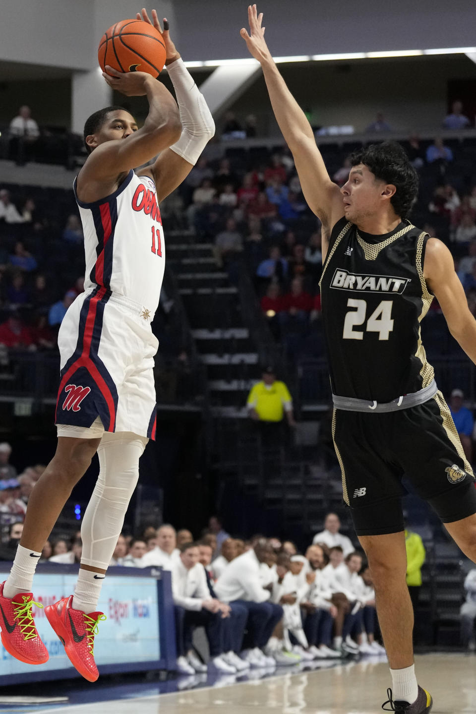 Mississippi guard Matthew Murrell (11) shoots over the defense of Bryant University guard Rafael Pinzon (24) during the first half of an NCAA college basketball game, Sunday, Dec. 31, 2023, in Oxford, Miss. (AP Photo/Rogelio V. Solis)