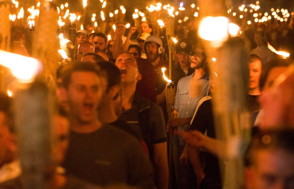 Neo Nazis, Alt-Right, and White Supremacists march with tiki torches through the University of Virginia campus the night before the 