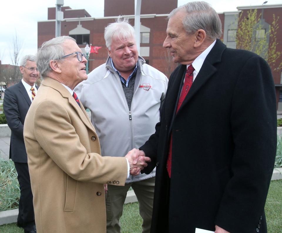 Gov. Mile DeWine, left, shakes hands with Canton Mayor Thomas M. Bernabei after arriving Tuesday at Centennial Plaza in Canton.