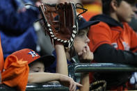 A fan waits for a fly ball during batting practice before Game 2 of baseball's World Series between the Houston Astros and the Atlanta Braves Wednesday, Oct. 27, 2021, in Houston. (AP Photo/Ashley Landis)