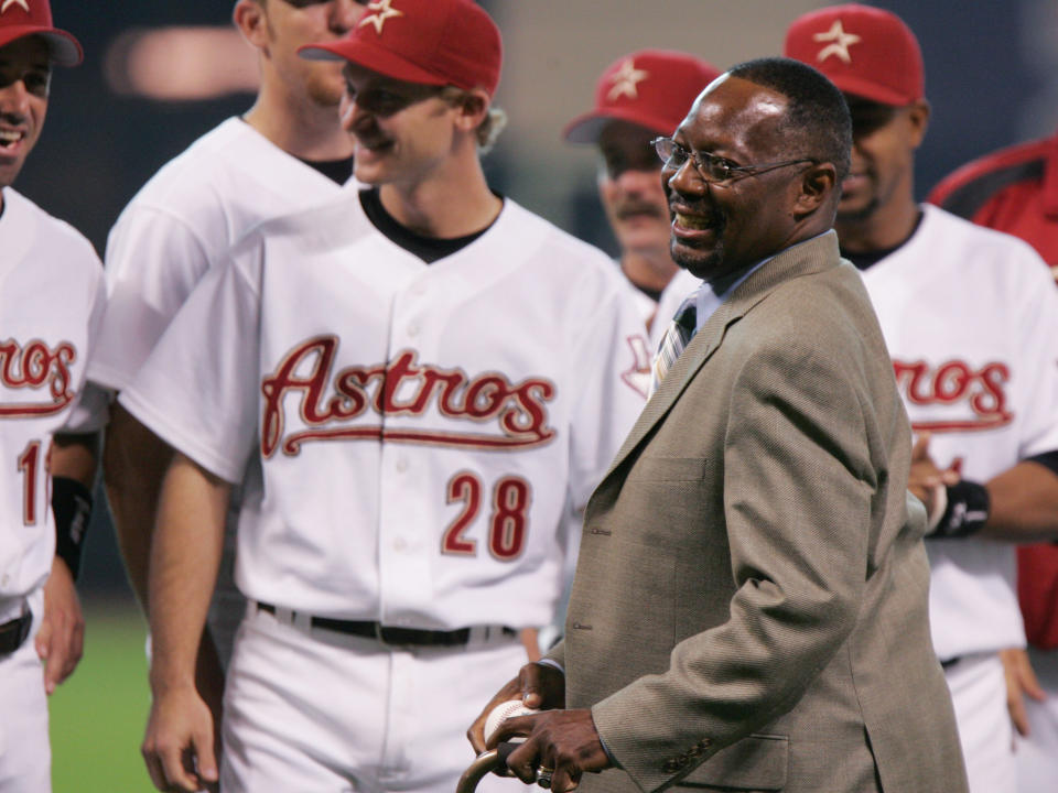 FILE - In this June 25, 2005, file photo, former Houston Astro Jimmy Wynn is joined by current players as he prepares to throw out the ceremonial first pitch after his jersey number was retired in Houston. Wynn, the slugger who earned his nickname of “The Toy Cannon” during his days with the Astros in the 1960s and '70s, has died. Wynn was 78. The Astros said he died Thursday, March 26, 2020, in Houston, but did not provide further details. (AP Photo/Pat Sullivan, File)