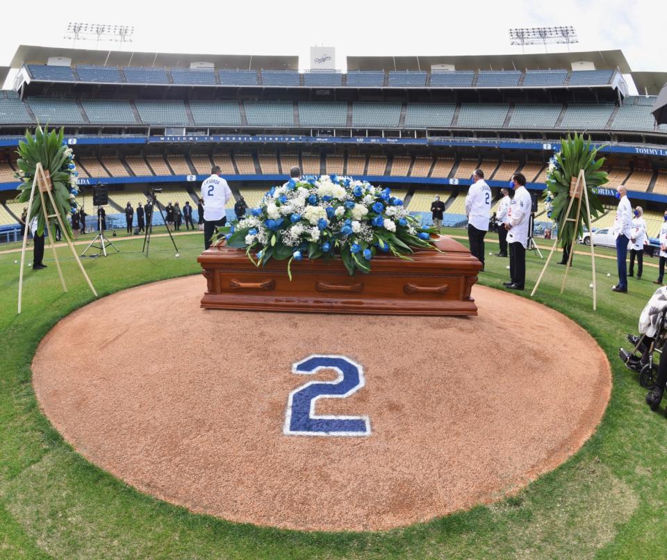 A casket with Tommy Lasorda sits on top of the pitchers mound at Dodger Stadium during a celebration of life ceremony.