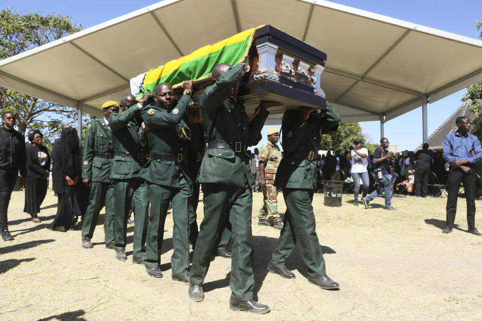 The coffin carrying the body of former Zimbabwean President Robert Mugabe is seen at during mass at his rural home in Zvimba, about 100 kilometers north west of the capital Harare, Saturday. Sept, 28, 2019. According to a family spokesperson Mugabe is expected to be buried at the residence after weeks of drama mystery and contention over his burial place. (AP Photo/Tsvangirayi Mukwazhi)