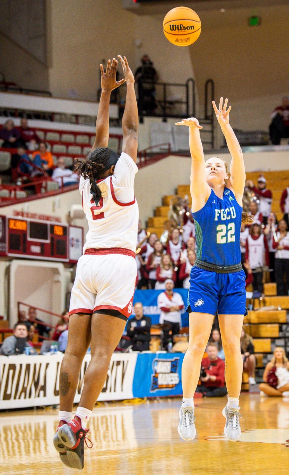 Florida Gulf Coast's Brylee Bartram (22) makes a three-pointer over Oklahoma's Reyna Scott (2) during first round NCAA action at Simon Skjodt Assembly Hall on Saturday, March 23, 2204.
