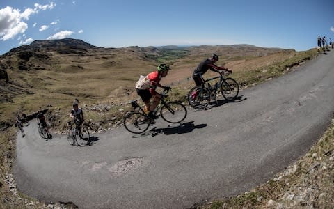 Robin Hough rides up the Lake District's infamously grueling Hardknott Pass - Credit: Steve Fleming/SteveFlemingPhoto.com