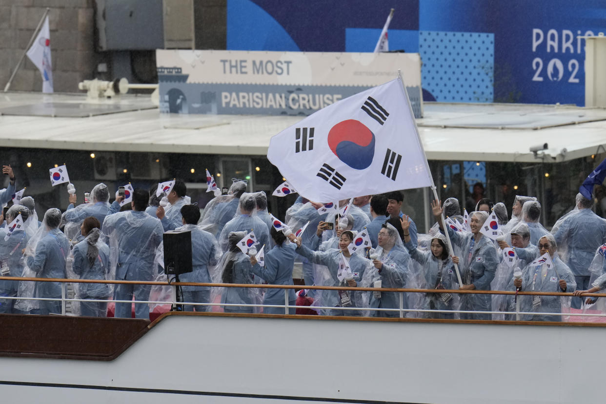 Athletes of South Korea travel by boat along the Seine river during the opening ceremony of the 2024 Summer Olympics, in Paris, France, Friday, July 26, 2024. (AP Photo/Ariana Cubillos)