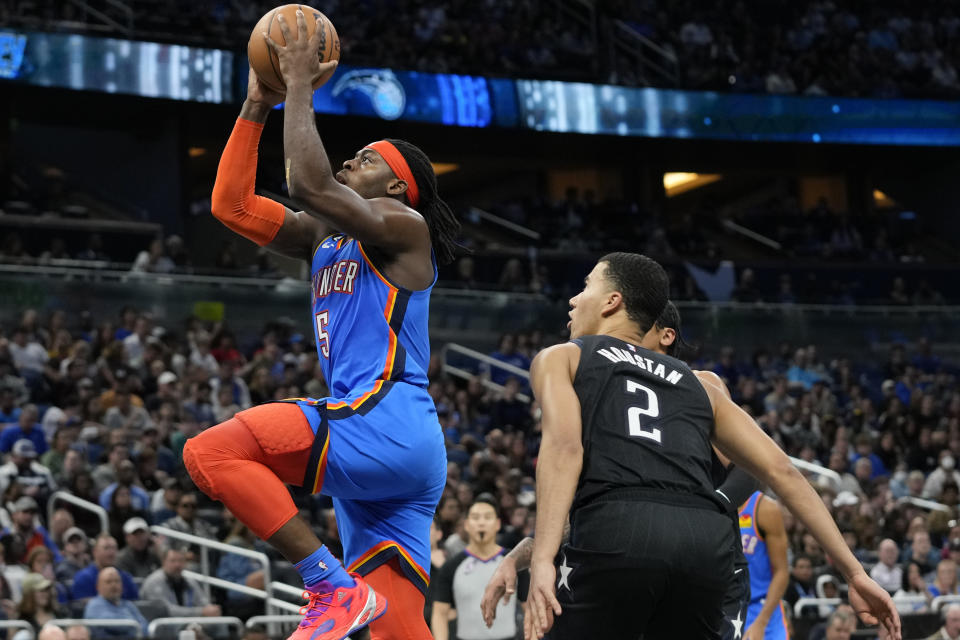Oklahoma City Thunder's Luguentz Dort (5) shoots in front of Orlando Magic's Caleb Houstan (2) during the first half of an NBA basketball game Wednesday, Jan. 4, 2023, in Orlando, Fla. (AP Photo/John Raoux)