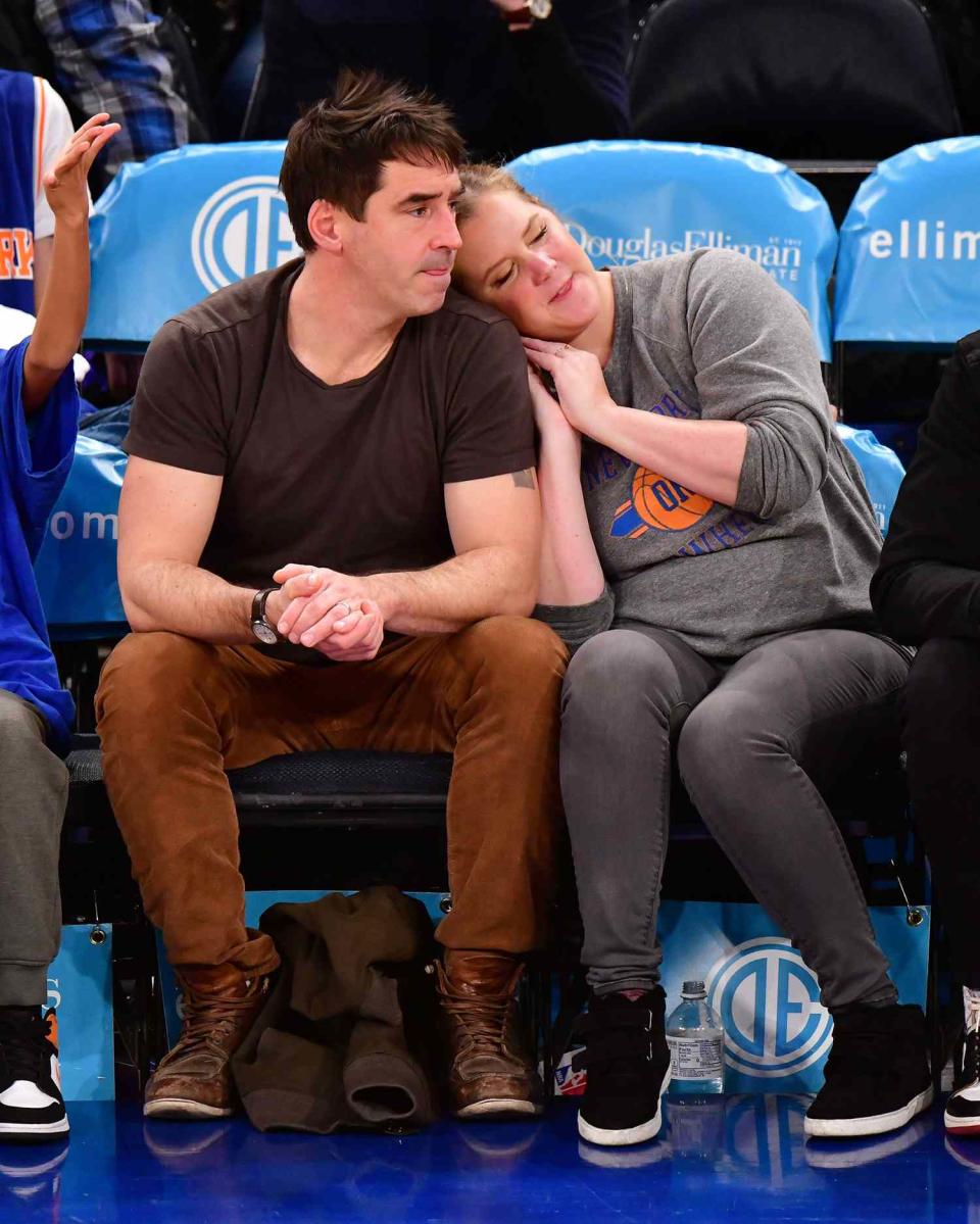 Chris Fischer and Amy Schumer attend Washington Wizards v New York Knicks game at Madison Square Garden on December 23, 2019 in New York City