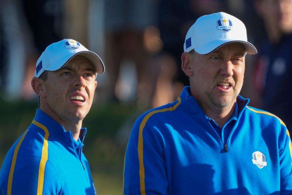 Rory McIlroy and Ian Poulter look over a shot on the second hole during their foursomes match at the Ryder Cup (Charlie Neibergall/AP) (AP)