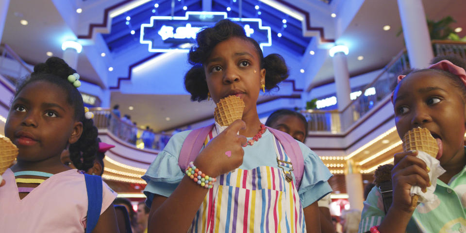 This image released by Netflix shows Priah Ferguson, center, in a scene from "Stranger Things." The scene was shot on location at the Gwinnett Place Mall in Duluth, Ga. (Netflix via AP)