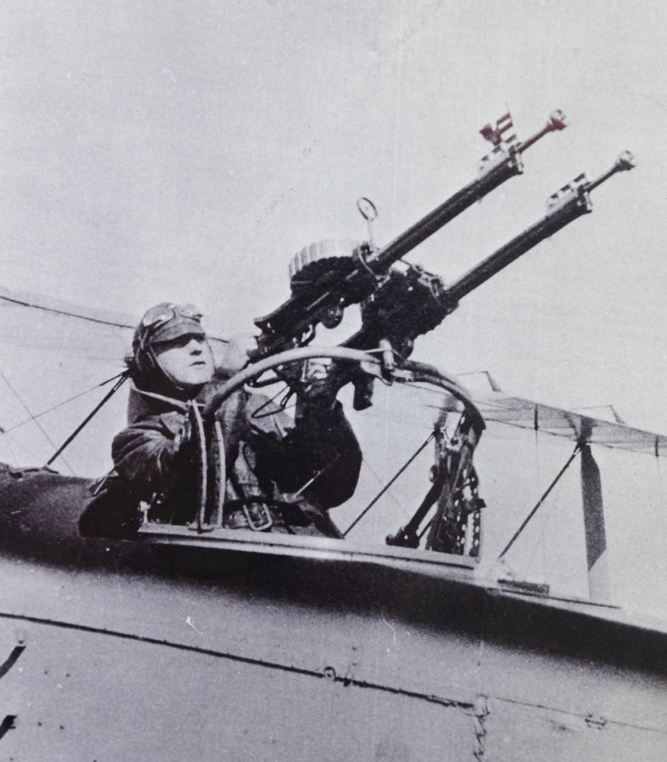 Erwin Bleckley poses at the machine guns he manned as an observer with the 50th Aero Squadron in World War I.