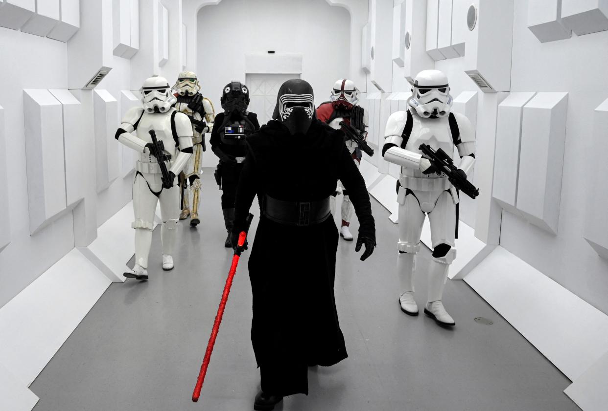 People dressed as Star Wars characters Kylo Ren and Stormtroopers walk along a corridor on the opening day of a "Star Wars" exhibition in 2023 near Madrid. The elite soldiers bear a striking similarity to the Sardaukar forces of Dune.