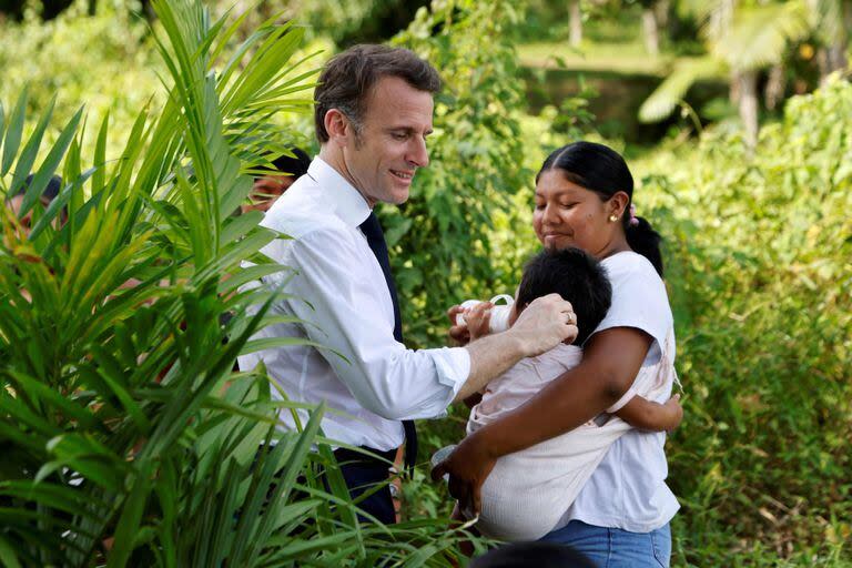 El presidente francés, Emmanuel Macron, saluda a la gente en la aldea de Camopi, como parte de una visita de dos días al departamento francés de ultramar de la Guayana, el 25 de marzo de 2024.