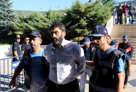 Major Sukru Seymen (C), one of the military personnel suspected of being involved in the coup attempt, is brought to a court house as he is accompanied by police officers and other detaniees in Mugla, Turkey, August 17, 2016. REUTERS/Kenan Gurbuz