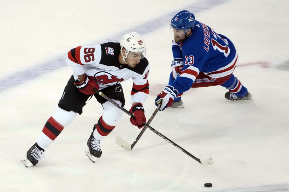 New Jersey Devils right wing Timo Meier (96) skates against New York Rangers left wing Alexis Lafrenière (13) during the second period of an NHL hockey game, Saturday, April 29, 2023, at Madison Square Garden in New York. (AP Photo/Mary Altaffer)