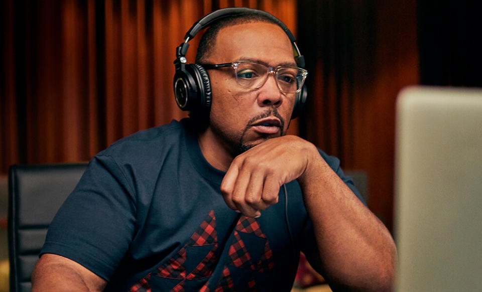 a picture of timbaland wearing headphones and working on a computer
