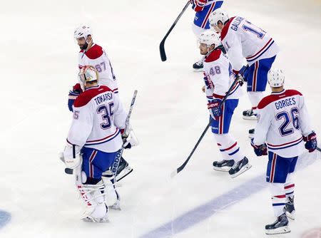 May 25, 2014; New York, NY, USA; Montreal Canadiens goalie Dustin Tokarski (35) skates off the ice with his teammates after game four of the Eastern Conference Final of the 2014 Stanley Cup Playoffs against the New York Rangers at Madison Square Garden. Mandatory Credit: Andy Marlin-USA TODAY Sports