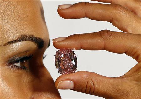A model displays the 'Pink Star' 59.60 carat oval cut pink diamond at Sotheby's in Geneva September 25, 2013. REUTERS/Ruben Sprich