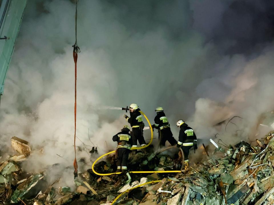 Emergency personnel work at the site where an apartment block was heavily damaged by a Russian missile strike, amid Russia's attack on Ukraine, in Dnipro, Ukraine January 15, 2023.