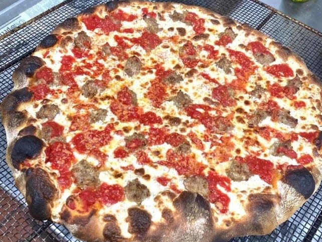 New York pizza with sausage from Sam's Coal Fired Pizza's then frozen pizza business.