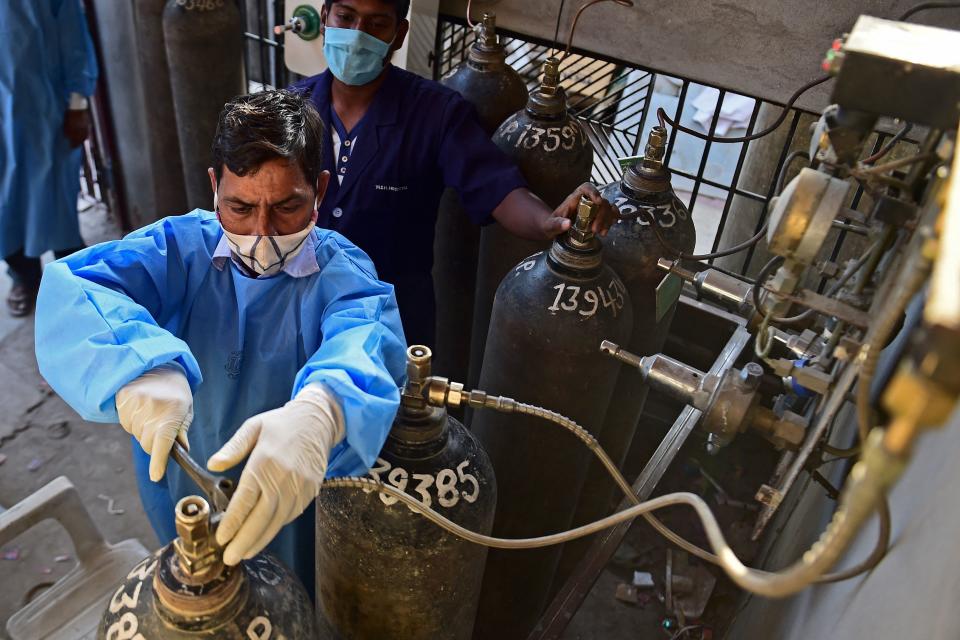 A health worker adjusts an oxygen cylinder at a private hospital in Allahabad, India.