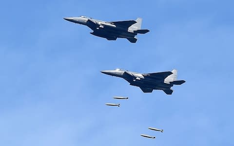 In this handout image provide by South Korean Defense Ministry, South Korea's F-15K fighter jets drop bombs during a training at the Taebaek Pilsung Firing Range - Credit: South Korean Defense Ministry via Getty Images