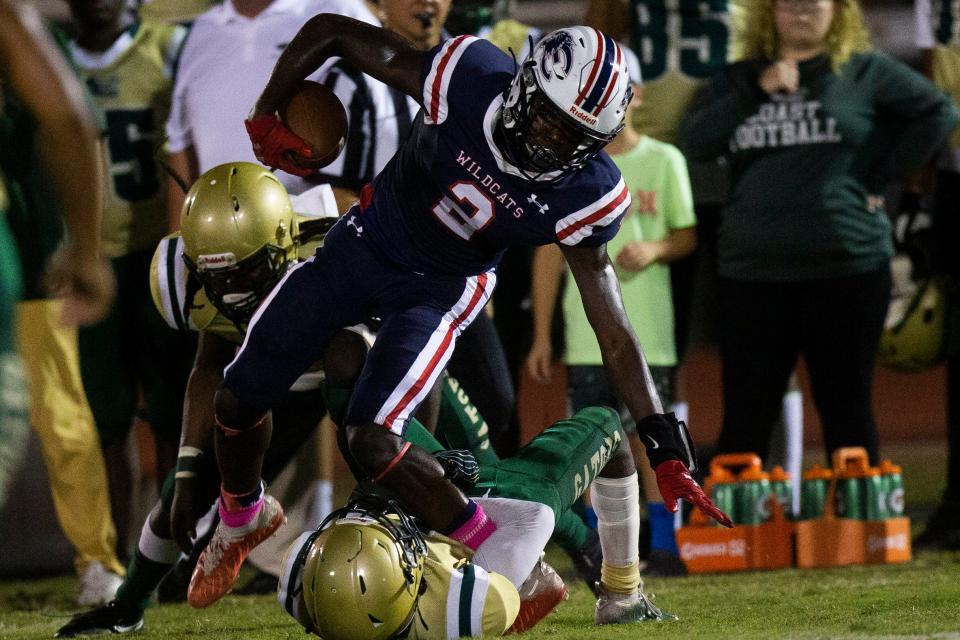 Estero's Jason Duclona (2) is tackled by Island Coast's defense on Oct. 22, 2021, at Estero High School.