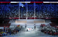 The national flag of Japan is handed over to members of the Japan Self-Defense Forces by flag bearers Motoki Iwakiri (Athletics), Tomoki Sato (Athletics), Miyuki Yamada (Swimming), Sakura Koike (Swimming), Kazuyasu Minobe (Fencing) and Keiko Yamamoto (Nurse) during the closing ceremony of the Tokyo 2020 Paralympic Games in Tokyo, Japan, Sunday, Sept. 5, 2021. (Joe Toth for OIS via AP)