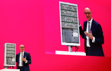 Timotheus Hoettges, CEO of Deutsche Telekom AG, appears on a screen as he stands in front of a 5G antenna of Swedish network infrastructure provider Ericsson during the company's annual shareholder meeting in Bonn, Germany March 28, 2019. REUTERS/Wolfgang Rattay