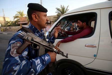 Iraqi security forces stand guard near the main provincial government building Basra, Iraq July 14, 2018. Picture taken July 14, 2018. REUTERS/Essam al-Sudani