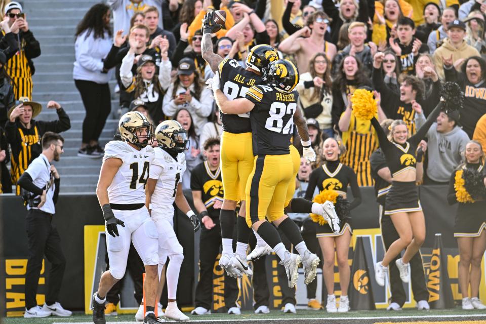 Oct 7, 2023; Iowa City, Iowa, USA; Iowa Hawkeyes tight end Erick All (83) reacts with tight end Johnny Pascuzzi (82) after scoring on a touchdown pass from quarterback Deacon Hill (not pictured) as Purdue Boilermakers Markevious Brown (1) and linebacker Yanni Karlaftis (14) look on during the fourth quarter at Kinnick Stadium.