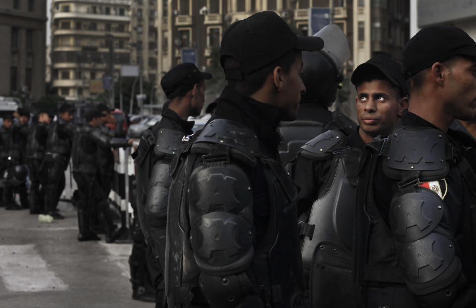 FILE -- In this May 3, 2016 file photo, security forces close off a street near the Egyptian Press Syndicate during a protest by journalists, in Cairo, Egypt. The Supreme Media Regulatory Council has put into effect tighter restrictions that allow the state to block websites and even social media accounts with over 5,000 followers if they're deemed a threat to national security. The media regulator will also be able to impose stiff penalties of 250,000 Egyptian pounds ($14,400), all without having to obtain a court order. (AP Photo/Nariman El-Mofty, File)