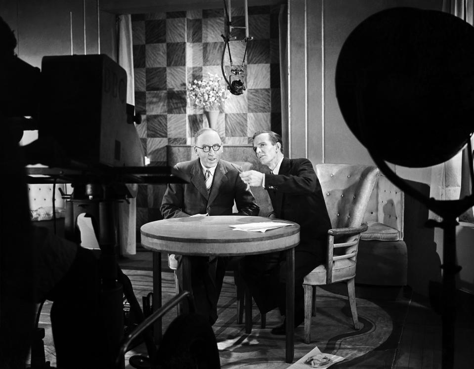Television announcer Mr. McDonald-Hobley (right) with a guest being televised at the Radio Exhibition (Radiolympia), 30th September 1947.