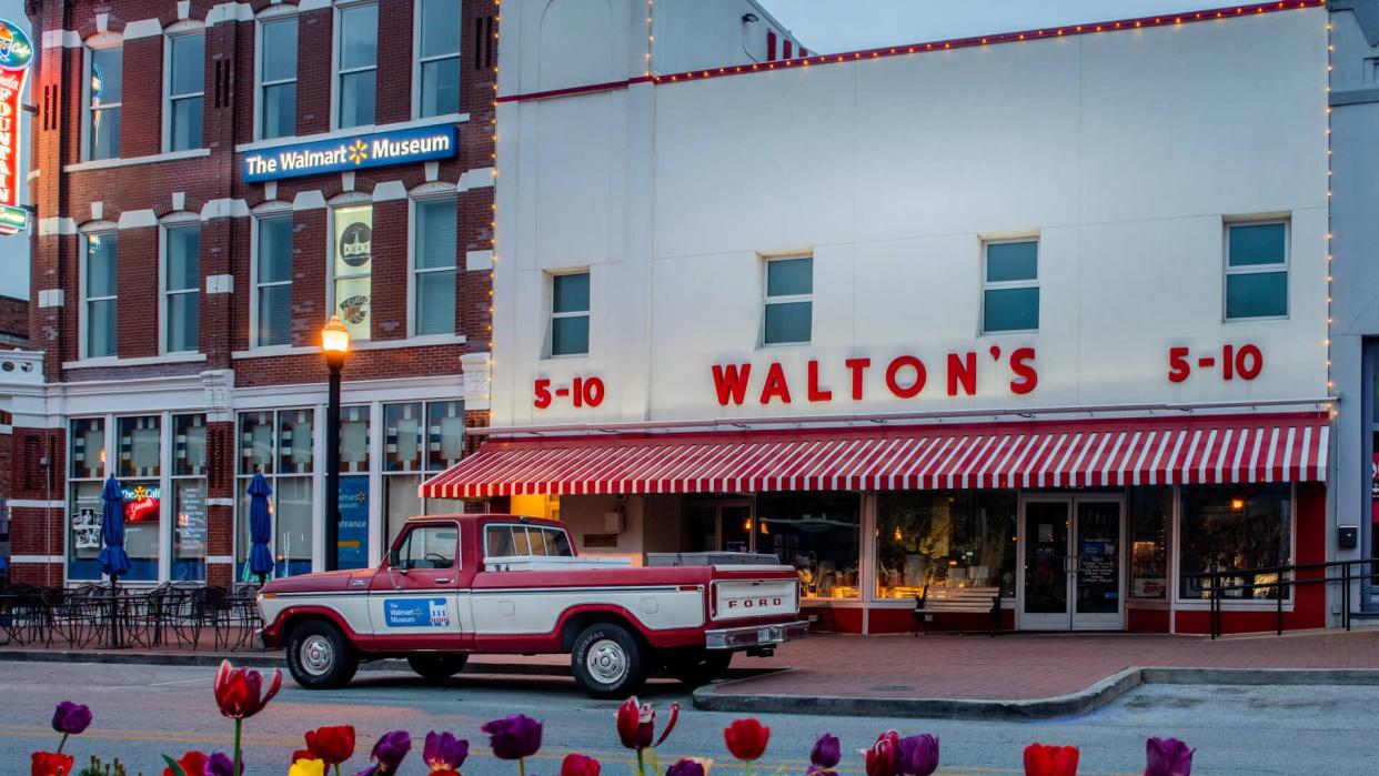 Bentonville, AR—April 11, 2019; old red and white ford truck that belonged to Sam Walton parked in front of first Walmart store which now serves as a corporate museum near the Arkansas headquarters.
