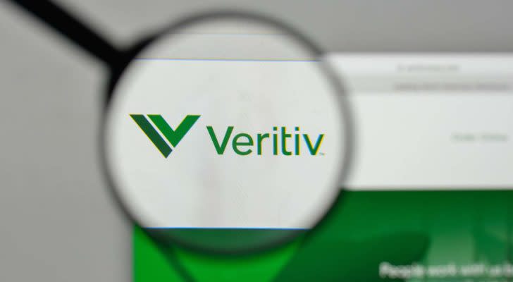 A magnifying glass zooms in on the website for Veritiv (VRTV).