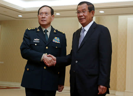 Chinese Defense Minister Wei Fenghe (L) shakes hands with Cambodia's Prime Minister Hun Sen before a meeting in Phnom Penh, Cambodia June 18, 2018. REUTERS/Samrang Pring