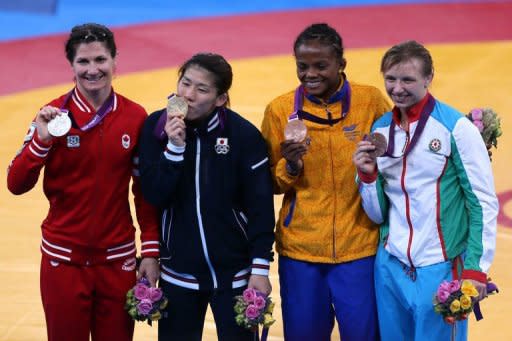 L-R: Silver medallist Canada's Tonya Lynn Verbeek, gold medallist Japan's Saori Yoshida and bronze medallists Colombia's Jackeline Renteria Castillo and Azerbaijan's Yuliya Ratkevich pose on the podium after the women's 55kg freestyle medal finals during the wrestling event of the London 2012 Olympic Games