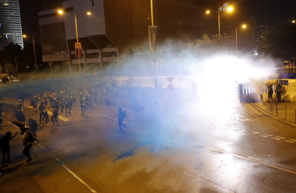 Police use water cannon to disperse protestors in Hong Kong, Saturday, Sept. 28, 2019. A pro-democracy rally in downtown Hong Kong has ended early amid sporadic violence, with police firing tear gas and a water cannon after protesters threw bricks and Molotov cocktails at government offices. (AP Photo/Vincent Thian)