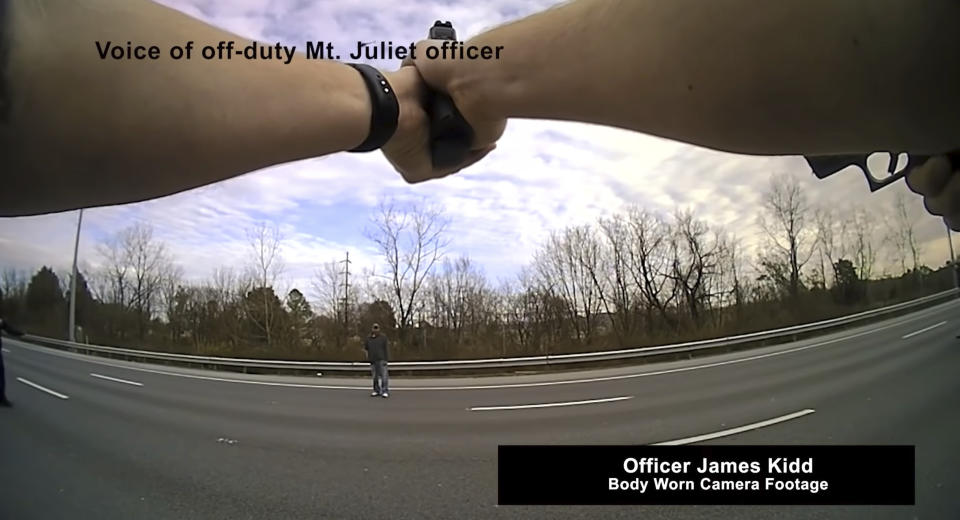 This still image from police body cam released by Metropolitan Nashville Police Department shows officers pleading with a man to surrender before shooting him on Jan. 28, 2022 in Nashville, Tenn. Tennessee police officers repeatedly pleaded with a man who stopped traffic along Interstate 65 to drop a box cutter and surrender, saying no one wanted to hurt him. Instead, he abruptly pulled another shiny object from his pocket and pointed it at police as if ready to shoot, prompting nine of the officers who surrounded him at gunpoint to open fire, killing him on the highway, according to officials and body camera video. (Metropolitan Nashville Police Department via AP)