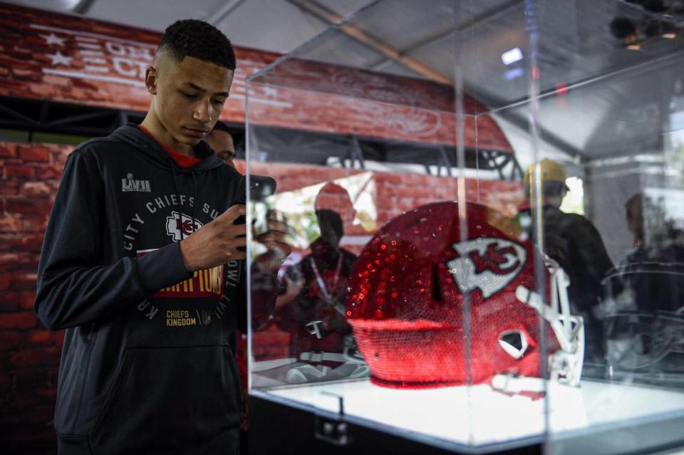 Uriah Santillan, 14, checked out the bejeweled Kansas City Chiefs helmet in the Chiefs Kingdom area at the NFL Draft Experience Thursday, April 27, 2023, at the National WWI Museum and Memorial in Kansas City.