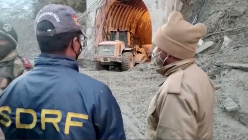 Excavator exits a tunnel in Chamoli, Uttarakhand, India during a rescue operation after a glacier burst in this still frame taken from video dated