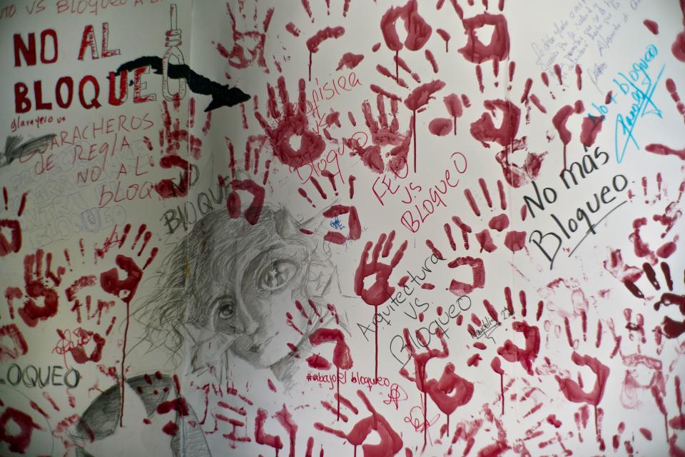 Hand prints of students are seen on a wall during an event against U.S. trade embargo against Cuba in Havana, Cuba, Wednesday, Oct. 31, 2018. The United Nations will vote Thursday Nov. 1 on a resolution regarding the ongoing U.S. trade embargo against Cuba. (AP Photo/Ramon Espinosa)