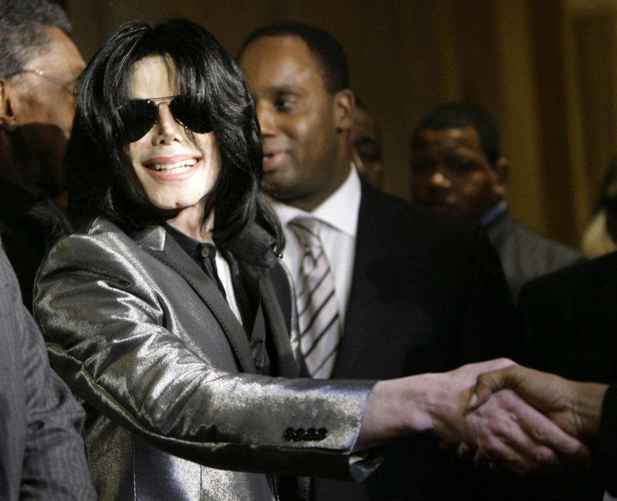 Pop star Michael Jackson shakes someones hand on the red carpet during the RainbowPUSH Coalition Los Angeles 10th annual awards dinner celebrating Jesse Jackson’s 66th birthday, on Thursday, Nov. 8, 2007 in Los Angeles.. (AP Photo/Danny Moloshok)