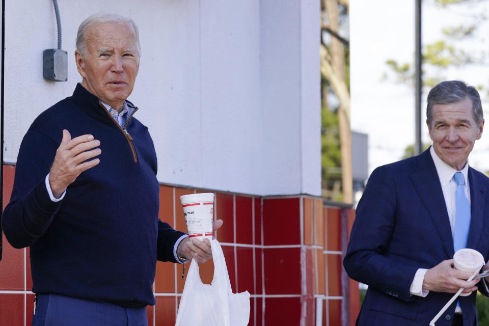 FILE - President Joe Biden speaks outside Cook Out, a burger joint in Raleigh, N.C., Jan. 18, 2024, as Gov. Roy Cooper, D-N.C., right, looks on. Twenty-three million families will either have to pay more for internet or cancel their subscriptions altogether if a federal subsidy program to help with the monthly bill runs out of money in April, 2024. The potential expiration of the program comes as Biden recently touted his administration's goal of internet for all in North Carolina, where more than 900,000 families receive the benefit. (AP Photo/Manuel Balce Ceneta, File)