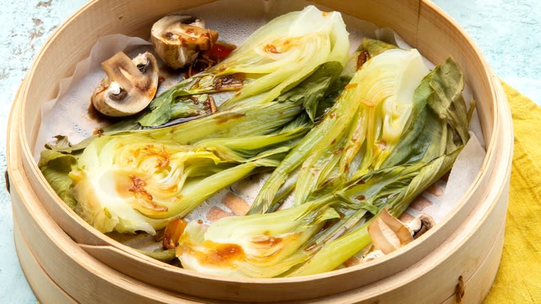 Bok choi and mushrooms in bamboo steamer