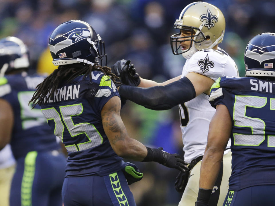 Seattle Seahawks cornerback Richard Sherman (25) and New Orleans Saints tight end Jimmy Graham (80) confront each other during the second half of an NFC divisional playoff NFL football game in Seattle, Saturday, Jan. 11, 2014. (AP Photo/Ted S. Warren)