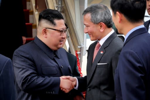 Kim is welcomed by Singapore's Foreign Minister Vivian Balakrishnan (center-R) upon his arrival at Singapore International airport