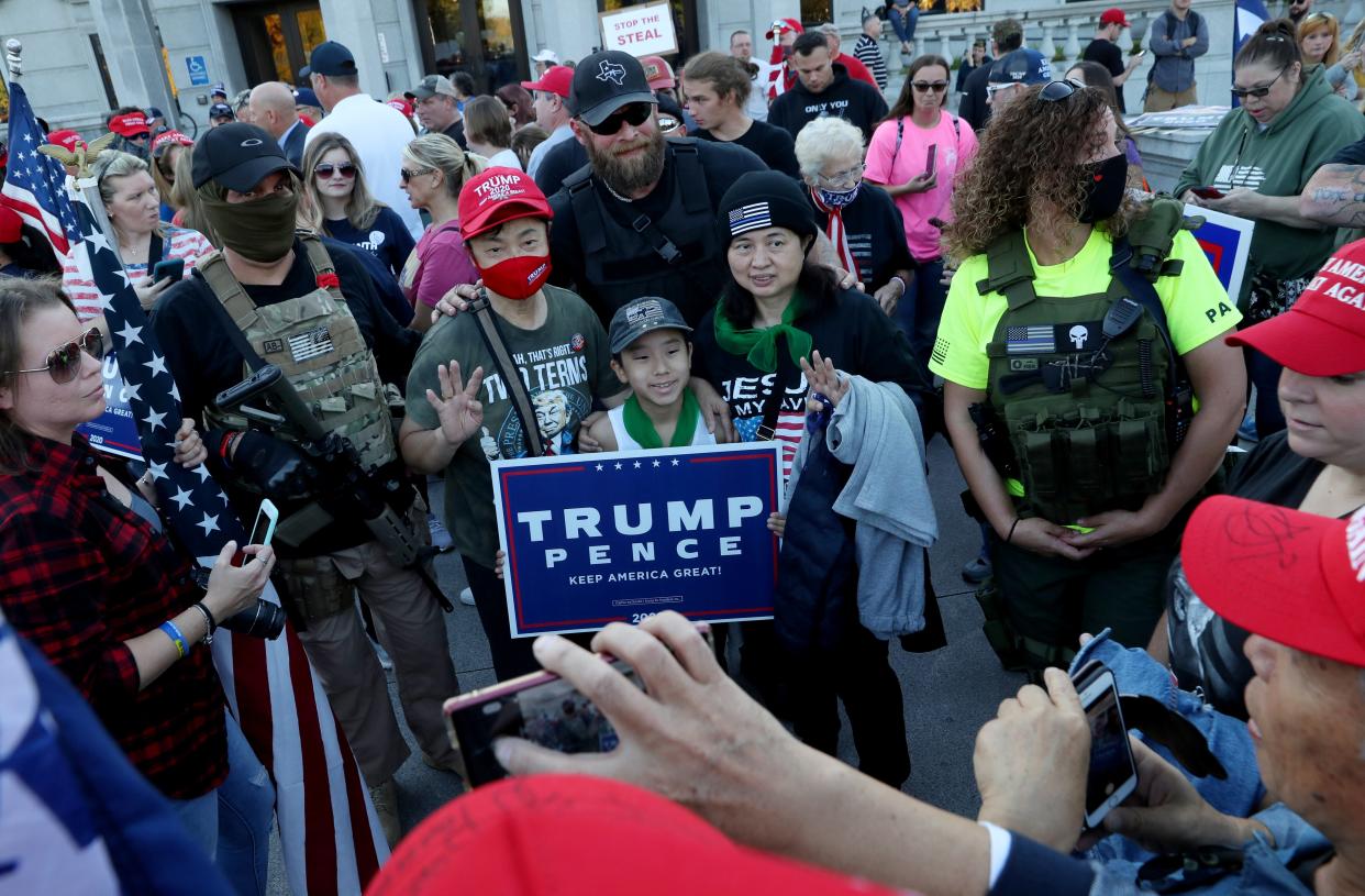 <p>File: Militia members at a rally in support of Donald Trump stand outside the State Capitol building in Harrisburg, Pennsylvania, after Biden was projected as the winner of the election</p> (REUTERS)